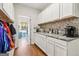 Butler's pantry with granite countertops and storage cabinets at 283 Rosebay Ln, Sharpsburg, GA 30277