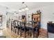 Dining room features a long table, hardwood floors, and a view of the kitchen at 283 Rosebay Ln, Sharpsburg, GA 30277
