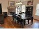 Elegant dining room featuring hardwood floors, stone fireplace, and ample seating at 283 Rosebay Ln, Sharpsburg, GA 30277