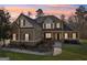 Inviting two-story home featuring a beautifully landscaped front yard and covered entry at 283 Rosebay Ln, Sharpsburg, GA 30277