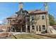 Rear view of the home showcasing a large deck and patio area for outdoor enjoyment at 283 Rosebay Ln, Sharpsburg, GA 30277
