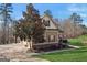 Charming home exterior with manicured lawn, tree lined property, and driveway at 283 Rosebay Ln, Sharpsburg, GA 30277