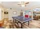 The game room features a ping pong table, light fixture, and hardwood flooring at 283 Rosebay Ln, Sharpsburg, GA 30277