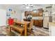 The kitchen features wood cabinets, dining table, hardwood flooring and a stainless steel refrigerator at 283 Rosebay Ln, Sharpsburg, GA 30277