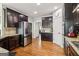 Modern kitchen with dark wood cabinets, stainless steel appliances, and granite countertops at 283 Rosebay Ln, Sharpsburg, GA 30277