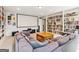 Comfortable living area with a large screen, sectional sofa, and built-in bookshelves at 283 Rosebay Ln, Sharpsburg, GA 30277