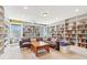 Inviting living room featuring a wall of built-in bookshelves and natural light at 283 Rosebay Ln, Sharpsburg, GA 30277