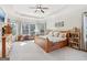 Spacious primary bedroom with a trey ceiling, large window, and wood furnishings at 283 Rosebay Ln, Sharpsburg, GA 30277