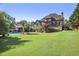 Expansive backyard featuring a lush lawn, mature trees, and a refreshing in-ground pool at 3704 Wilkins Cir, Powder Springs, GA 30127