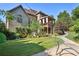 Lush backyard with a covered balcony, manicured lawn, and a winding pathway leading to outdoor spaces at 3704 Wilkins Cir, Powder Springs, GA 30127