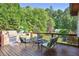 Spacious backyard deck with outdoor kitchen, comfortable seating, and lush landscaping at 3704 Wilkins Cir, Powder Springs, GA 30127