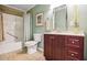 The bathroom features a shower and tub with a modern vanity and a large mirror at 3704 Wilkins Cir, Powder Springs, GA 30127