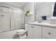 A bathroom featuring a shower with glass doors, a toilet, a vanity and mirror at 3704 Wilkins Cir, Powder Springs, GA 30127