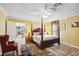 Relaxing bedroom with a four-poster bed, neutral decor, and an open doorway to another room at 3704 Wilkins Cir, Powder Springs, GA 30127