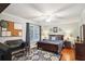 Cozy bedroom with hardwood floors, a comfortable bed, and a functional desk area, perfect for study or work at 3704 Wilkins Cir, Powder Springs, GA 30127