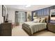 This bedroom showcases a bed, natural lighting from a window, neutral walls, and wood furnishings at 3704 Wilkins Cir, Powder Springs, GA 30127
