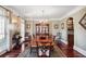 Formal dining room with hardwood floors, large window, and classic chandelier creates an elegant space at 3704 Wilkins Cir, Powder Springs, GA 30127