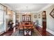 Formal dining room with hardwood floors, elegant chandelier, and ample seating for gatherings at 3704 Wilkins Cir, Powder Springs, GA 30127