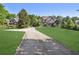 Long driveway leading to a two-story home with mature trees and an expansive front yard at 3704 Wilkins Cir, Powder Springs, GA 30127