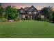 Beautiful brick house with mature landscaping and a well-maintained front yard, showcasing curb appeal at 3704 Wilkins Cir, Powder Springs, GA 30127
