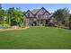 Charming two-story brick home featuring a lush green lawn and beautifully landscaped front yard at 3704 Wilkins Cir, Powder Springs, GA 30127