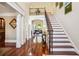 Elegant foyer showcasing hardwood floors, a staircase, and views into the living room at 3704 Wilkins Cir, Powder Springs, GA 30127