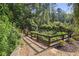 Picturesque garden area enclosed by a rustic wooden fence, featuring raised beds and thriving plants at 3704 Wilkins Cir, Powder Springs, GA 30127