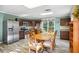 Charming kitchen featuring stainless steel appliances, dark cabinetry, and a large dining table at 3704 Wilkins Cir, Powder Springs, GA 30127