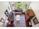 Cozy living room with a leather sectional sofa, a patterned rug, and arched windows at 3704 Wilkins Cir, Powder Springs, GA 30127
