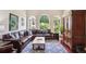 Spacious living room with hardwood floors, large windows, and a comfortable leather sectional at 3704 Wilkins Cir, Powder Springs, GA 30127