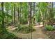 A gravel path winds through a lush, green forest, offering a tranquil and private setting at 3704 Wilkins Cir, Powder Springs, GA 30127