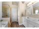 Well-lit bathroom featuring dual sinks, modern fixtures, a tiled shower and a separate tub at 877 Ashwood Walk, Decatur, GA 30030