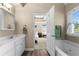 Bright bathroom showcasing a dual vanity, soaking tub, and elegant finishes viewed from the door to the main bedroom at 877 Ashwood Walk, Decatur, GA 30030