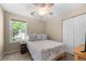 Cozy bedroom with natural light from the window, paired with comfortable decor and ample closet space at 877 Ashwood Walk, Decatur, GA 30030