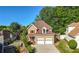 Two-story home featuring a two-car garage, a well-manicured lawn, and mature trees at 877 Ashwood Walk, Decatur, GA 30030