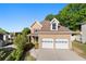 Beautiful two-story home with a two-car garage, mature trees, and well-maintained landscaping at 877 Ashwood Walk, Decatur, GA 30030