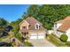 Charming two-story home with a well-manicured lawn, mature trees, and a two-car garage at 877 Ashwood Walk, Decatur, GA 30030