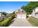 Charming two-story home with a well-manicured lawn and a two-car garage at 877 Ashwood Walk, Decatur, GA 30030