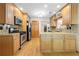 Well-lit kitchen featuring granite countertops, stainless steel appliances, and wooden cabinets at 877 Ashwood Walk, Decatur, GA 30030