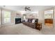Spacious living room with a fireplace, ceiling fan, and carpeted flooring at 877 Ashwood Walk, Decatur, GA 30030