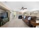 Comfortable living room with fireplace, fan, large TV, and view to dining area at 877 Ashwood Walk, Decatur, GA 30030