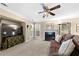 Comfortable living room with fireplace, fan, large TV, and view to dining area at 877 Ashwood Walk, Decatur, GA 30030