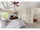 Comfortable main bedroom featuring tray ceilings, fan, and large windows, creating a relaxing retreat at 877 Ashwood Walk, Decatur, GA 30030