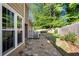 Stone backyard patio and lawn with garden and white fence offer a perfect outdoor space at 877 Ashwood Walk, Decatur, GA 30030