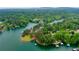 Stunning aerial view of a waterfront property, surrounded by green trees and docks at 3865 Adams Rd, Cumming, GA 30041