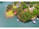 Stunning aerial view of waterfront property with docks and mature trees and landscaping at 3865 Adams Rd, Cumming, GA 30041