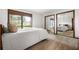 Bedroom with a neutral carpet, large window with curtains, mirrored closet doors, and a full-sized bed at 3865 Adams Rd, Cumming, GA 30041