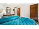 Bright bedroom with two twin beds with blue bedding, dresser, and wood doors at 3865 Adams Rd, Cumming, GA 30041