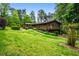 Charming multi-level home on lush green lawn with a welcoming deck and beautiful landscaping at 3865 Adams Rd, Cumming, GA 30041