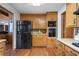 Efficient kitchen space with wooden cabinets, black refrigerator, and built-in oven at 3865 Adams Rd, Cumming, GA 30041